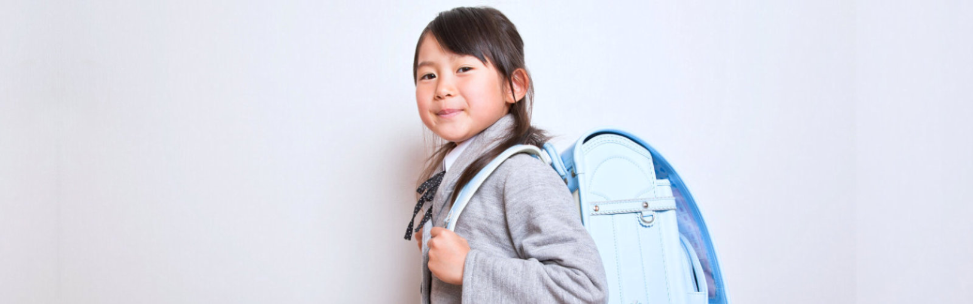 young girl wearing bag